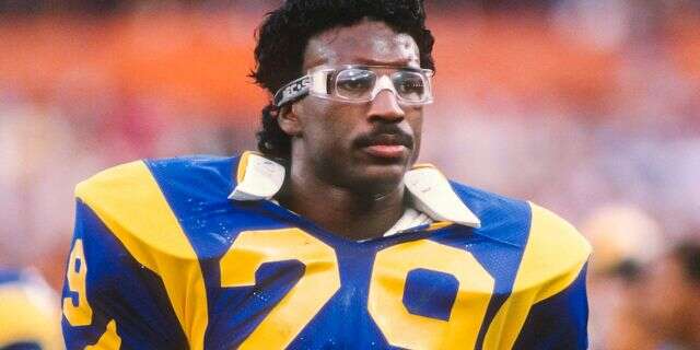 Eric Dickerson #29 of the Los Angeles Rams waits on the sidelines a National Football League game against the Houston Oilers played on December 17, 1984 at Anaheim Stadium in Anaheim, California. Dickerson set a new NFL single season rushing record during the game. (Photo by David Madison/Getty Images)