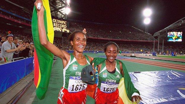 Derartu Tulu (left) celebrates breaking an Olympic Record after winning the women's 10,000m at the 2000 Olympic Games in Sydney.
